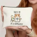 White canvas makeup bag featuring a cute hamster painter graphic and zipper closure for daily use. - Hamster Painter