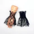 Detailed view of black sheer mesh ruffle cuffs with polka dot print for fashion party wear. - Black Polka Dot