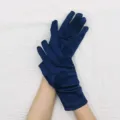 Detailed view of short stretch satin gloves in deep blue, elegant material and fine finish. - Navy Blue