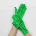 Close-up detail of vibrant green short satin gloves, elegant glossy stretch fabric for evening wear. - Green