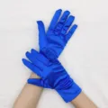 Detail view of royal blue short stretch satin gloves, elegant shiny finish for evening party. - Blue
