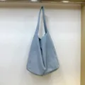Dettaglio borsa shopper a spalla in tela azzurro chiaro casual, grande borsa da lavoro. - Blu