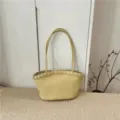 Detail view of the elegant light yellow woven leather shoulder bag with spacious interior design. - Light Yellow