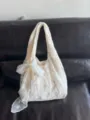 Detailed shot of cream white lace tote bag, elegant bow accent, chic casual style. - Off White