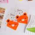 Dettaglio di sacchetti per biscotti caramelle orsetto adesivi con design in plastica trasparente. - 100 Pezzi/Confezione (10*10+3 cm) / Orso Arancione