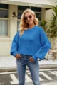 Detailed view of the stylish blue knit sweater worn by a female model in an outdoor cafe scene. - XS / Blue