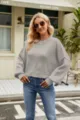 Detailed view of the gray loose crewneck long sleeve knit sweater in casual street scene. - XS / Gray