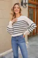 Casual striped knitwear detail shot, soft fabric, relaxed fit, stylish autumn fashion look. - White Striped