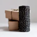 Black and gold metallic cotton twine spool for gift wrapping, crafts and decorative packaging. - Black with Gold Thread