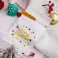Christmas cookie packaging bag with golden ribbon and Merry Christmas festive design. - Gold Merry Christmas (Pack Of 48-50)
