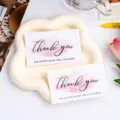 Detail view of thank you greeting cards with pink watercolor design on white cloud tray. - Style B / 30 Sheets