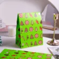 Dettaglio sacchetto regalo natalizio verde, con motivi festivi di caramelle e alberi. - 12x23x7.5cm / Pretzel a Cuore