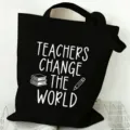 Close-up detail of the black canvas tote bag featuring white teacher theme print and durable fabric. - Style 12