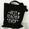 Black canvas tote bag detail showing the white best teacher ever print and sturdy handle design. - Style 7