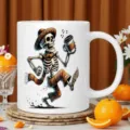 Detailed view of white ceramic coffee mug featuring Mexican calavera skeleton dancing design. - 350ml / Single Cup / White