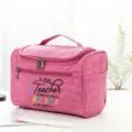 Detail view of pink teacher toiletry bag with quote print, handle and double zipper closure. - Style 15