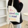 Detail shot of the aesthetic canvas tote bag with inspiring quote text, casual daily style. - Style 1