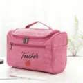 Pink teacher cosmetic bag detail, featuring cute apple print and portable handle for travel. - Style 9