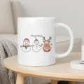 Cute Christmas ceramic coffee mug featuring snowman and reindeer illustrations for holiday gifts. - White (Cartoon Snowman and Reindeer B)