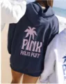Detailed view of the dark blue hoodie featuring pink palm tree print and cozy dropped shoulders. - XS / Tops / Navy Blue