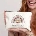 Detailed view of white canvas teacher appreciation makeup bag with rainbow design and custom name. - Style 1