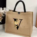 Detailed view of the large capacity jute tote bag featuring elegant floral letter V design. - Floral Alphabet-V