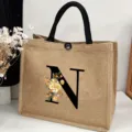 Large capacity jute tote bag with black letter N print and floral design for casual daily use. - Floral Alphabet-N