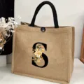 Detail view of the large burlap tote bag featuring floral letter S design and sturdy black handles. - Floral Alphabet-S