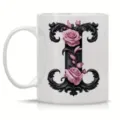 Ceramic coffee mug with elegant black initial letter and roses floral design detail. - Letter I