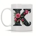 White ceramic coffee mug with elegant black floral letter K monogram, perfect for office use. - Letter K