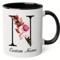Close-up detail of custom floral letter N ceramic mug featuring elegant black handle and rim. - 350ml / Letter N
