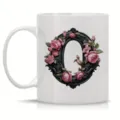 White ceramic coffee mug featuring an elegant black floral frame letter O design for office use. - Letter O