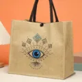 Large capacity jute tote bag with stylish evil eye print, retro canvas handbag for women daily use. - Evil Eye Style