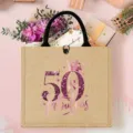 Close-up detail of the burlap tote bag with 50th birthday pink glitter crown print. - Birthday Crown Style