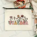 Detailed shot of canvas makeup bag with floral teacher letter print, neat zipper and texture. - Style 8