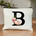Kosmetiktasche aus Leinen mit schwarzem Buchstaben B und Blumenmuster für Alltag. - Buchstabe B