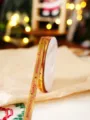 Detailansicht von goldenem Weihnachtsband mit Weihnachtstext und Sternen zum Geschenke verpacken. - Buchstabe Modell (1cmx22m)