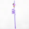 Primer plano de la creativa pajita de PVC en espiral violeta con bonito dije de flamenco. - Púrpura