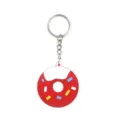 Closeup view of cute donut keychain with red PVC silicone, white frosting and colorful sprinkles. - Red