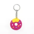 Detailed view of cute donut keychain, PVC material with colorful sprinkles and metal ring. - Rose Red