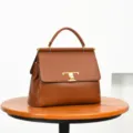 Brown leather top handle handbag with metal T-clasp, elegant flap commuting tote bag for women. - Brown