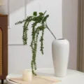 Planta artificial de bayas colgantes en jarrón de cerámica blanca para decoración. - Verde