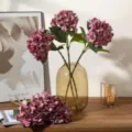 Artificial hydrangea flowers in glass vase faux floral home decor arrangement for room - Burgundy