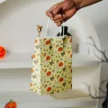 Halloween gift paper bag detail view showing cute pumpkin and ghost pattern design with handle. - 160x230x80mm / Yellow