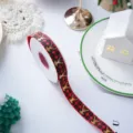 Red and black plaid Christmas ribbon with gold reindeer, perfect for gift wrapping and DIY crafts. - Red Plaid Reindeer