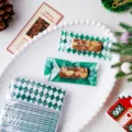 Detail shot of Christmas green and white checkered candy packaging bags with festive props. - Green 4-in-1 / 100 Pieces/Pack (4x9cm)