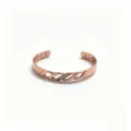 Detailed view of magnetic copper cuff bracelet with infinity twist design and cubic zirconia. - Copper-Tone With Rhinestone