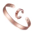 Detail view of the elegant rose gold magnetic copper bracelet and matching ring set closeup. - Set