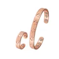 Close-up detail of magnetic copper cuff bracelet and ring set with engraved heart pattern. - Bracelet and Ring Set / Copper