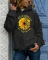 Detailed shot of women's black hooded sweatshirt showing the sunflower skull graphic. - S / Tops / Black